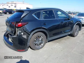 2021 Mazda CX-5 Touring with VIN JM3KFACM2M0339349, listed as a IAAI auction lot 41651005 with 53,792 mi miles. Bid and sale history available at carsss.com. Image 4.
