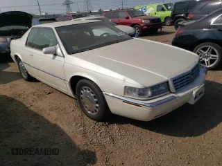 2000 Cadillac Eldorado z VIN 1G6EL12Y2YU179560, wystawiony jako Copart lot #70635784 z przebiegiem 92 959 mil mil oraz Tytuł czysty. Historia ofert i sprzedaży dostępna na DreamBid. Obrazek 4.