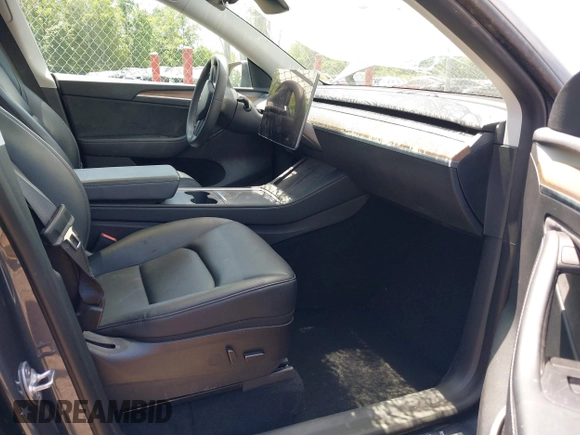 2023 Tesla Model Y Long Range with VIN 7SAYGAEE7PF615751, listed as a IAAI auction lot 42297819 with 31,201 mi miles and . Bid and sale history available at DreamBid. Image 5.