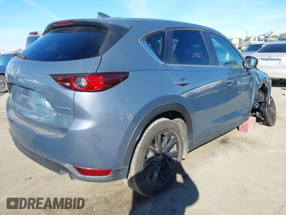 2021 Mazda CX-5 Touring with VIN JM3KFBCM9M0434433, listed as a IAAI auction lot 41425112 with 57,527 mi miles. Bid and sale history available at carsss.com. Image 4.