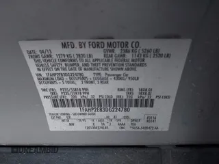 2013 Ford Taurus SEL with VIN 1FAHP2E83DG224780, listed as a IAAI auction lot 41675601 with 166,977 mi miles. Bid and sale history available at carsss.com. Image 9.