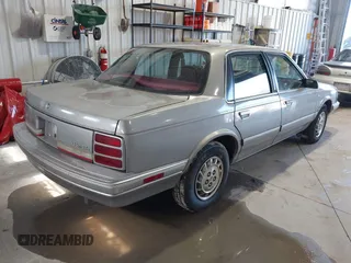 1996 Oldsmobile Cutlass Ciera 1SA VX5 z VIN 1G3AJ55M7T6328219, wystawiony jako IAAI lot #41663474 z przebiegiem 124 853 mil mil oraz . Historia ofert i sprzedaży dostępna na DreamBid. Obrazek 4.