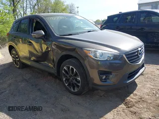 2016 Mazda CX-5 Grand Touring z VIN JM3KE4DY8G0846265, wystawiony jako IAAI lot #42102843 z przebiegiem 159 827 mil mil oraz . Historia ofert i sprzedaży dostępna na DreamBid. Obrazek 1.