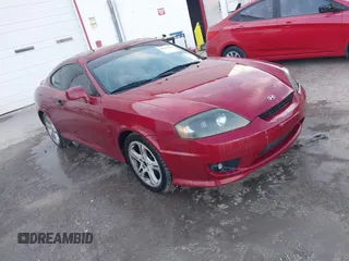 2006 Hyundai Tiburon GT z VIN KMHHN65FX6U229156, wystawiony jako IAAI lot #42082179 z przebiegiem 172 207 mil mil oraz . Historia ofert i sprzedaży dostępna na DreamBid. Obrazek 1.