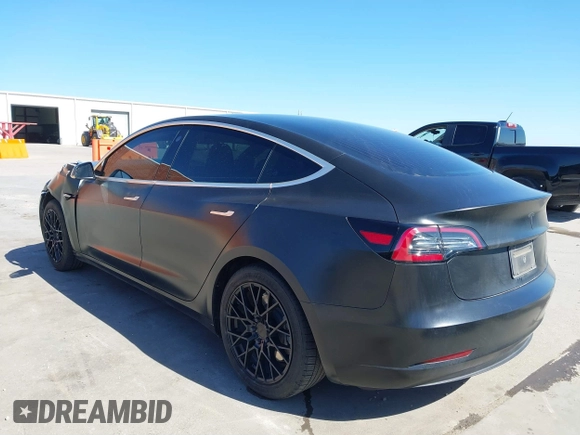 2020 Tesla Model 3 Standard Range Plus with VIN 5YJ3E1EA0LF597761, listed as a IAAI auction lot 41773918 with 89,957 mi miles. Bid and sale history available at carsss.com. Image 3.