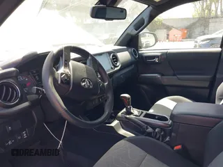 2023 Toyota Tacoma SR with VIN 3TMCZ5AN3PM590101, listed as a IAAI auction lot 42338670 with 12,970 mi miles and . Bid and sale history available at DreamBid. Image 6.