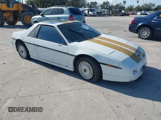 1986 Pontiac Fiero z VIN 1G2PF3797GP269850, wystawiony jako IAAI lot #40722755 z przebiegiem 129 077 mil mil oraz . Historia ofert i sprzedaży dostępna na DreamBid. Obrazek 1.