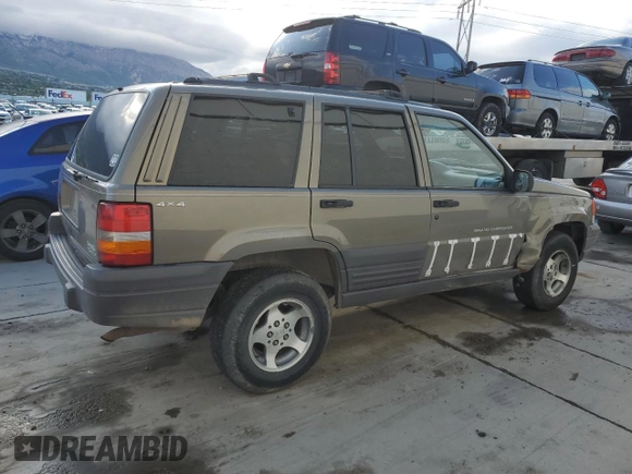 1996 Jeep Grand Cherokee Laredo with VIN 1J4GZ58S3TC245928, listed as a Copart auction lot 57313735 with 165,733 mi miles and Salvage title. Bid and sale history available at DreamBid. Image 3.