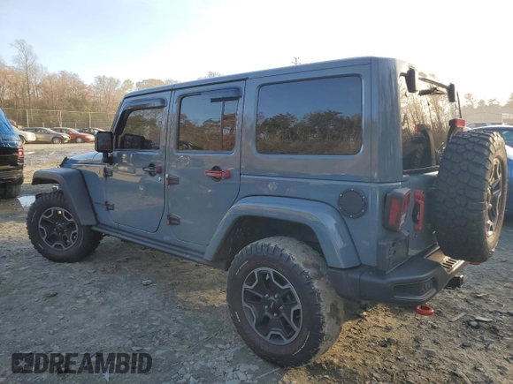 2015 Jeep Wrangler Unlimited Rubicon Hard Rock with VIN 1C4HJWFGXFL671660, listed as a Copart auction lot 82329074 with 214,579 mi miles and Salvage title. Bid and sale history available at DreamBid. Image 2.