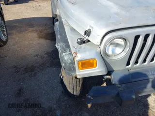 2004 Jeep Wrangler Sport Right Hand Drive with VIN 1J4F449SX4P780560, listed as a IAAI auction lot 41645721 with 146,681 mi miles. Bid and sale history available at carsss.com. Image 6.