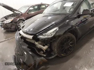 2021 Tesla Model Y Long Range with VIN 5YJYGAEE5MF305655, listed as a IAAI auction lot 41860993 with 50,750 mi miles. Bid and sale history available at carsss.com. Image 6.