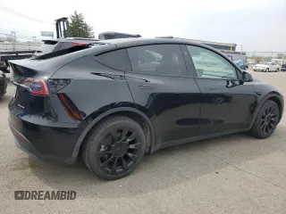 2023 Tesla Model Y Long Range z VIN 7SAYGDEE0PF869710, wystawiony jako Copart lot #52885365 z przebiegiem 13 919 mil mil oraz Szkoda całkowita • Salvage title. Historia ofert i sprzedaży dostępna na DreamBid. Obrazek 3.