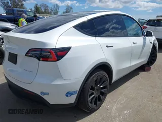 2020 Tesla Model Y Long Range with VIN 5YJYGDEE2LF058515, listed as a IAAI auction lot 41932748 with 62,885 mi miles and . Bid and sale history available at DreamBid. Image 4.