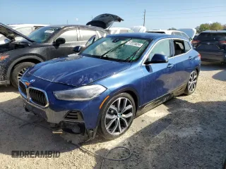 2021 BMW X2 sDrive28i with VIN WBXYH9C02M5S54591, listed as a Copart auction lot 77223834 with 0 mi miles and Salvage Title. Bid and sale history available at carsss.com. Image 1.
