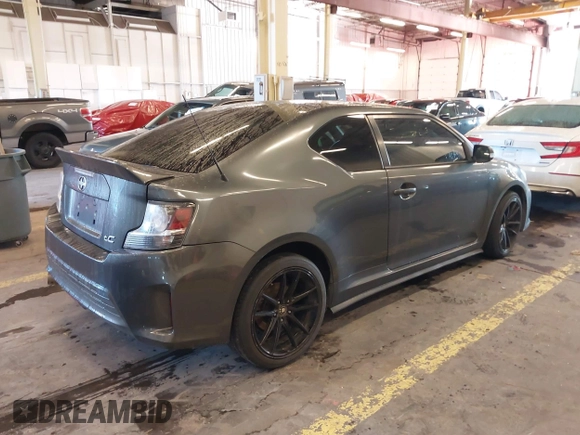 2014 Scion tC with VIN JTKJF5C77E3069906, listed as a IAAI auction lot 41243445 with 128,791 mi miles. Bid and sale history available at carsss.com. Image 4.