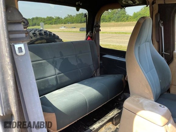 1999 Jeep Wrangler Sahara with VIN 1J4FY49S5XP496486, listed as a Copart auction lot 77263014 with 128,498 mi miles and Clean Title. Bid and sale history available at carsss.com. Image 6.