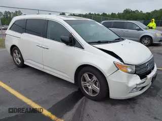 2013 Honda Odyssey Touring with VIN 5FNRL5H92DB091259, listed as a IAAI auction lot 42351006 with 113,665 mi miles and . Bid and sale history available at DreamBid. Image 1.