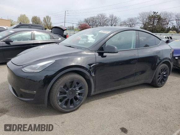 2023 Tesla Model Y Long Range z VIN 7SAYGDEE0PF869710, wystawiony jako Copart lot #52885365 z przebiegiem 13 919 mil mil oraz Szkoda całkowita • Salvage title. Historia ofert i sprzedaży dostępna na DreamBid. Obrazek 1.