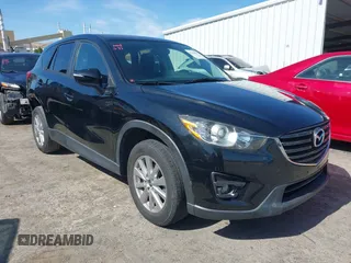 2016 Mazda CX-5 Touring z VIN JM3KE4CY2G0656270, wystawiony jako IAAI lot #42344489 z przebiegiem 60 449 mil mil oraz . Historia ofert i sprzedaży dostępna na DreamBid. Obrazek 1.