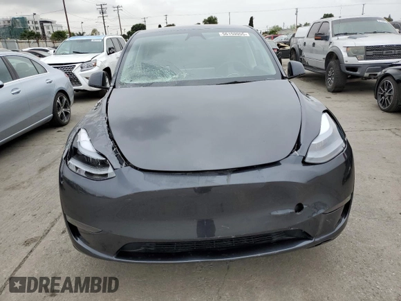 2025 Tesla Model Y Long Range with VIN 7SAYGDED4SF242721, listed as a Copart auction lot 56159955 with 7,131 mi miles and Salvage Title. Bid and sale history available at DreamBid. Image 5.