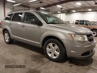 2015 Dodge Journey American Value z VIN 3C4PDCAB9FT675474, wystawiony jako IAAI lot #42078053 z przebiegiem 172 367 mil mil oraz . Historia ofert i sprzedaży dostępna na DreamBid. Obrazek 1.