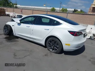 2020 Tesla Model 3 Standard Range Plus with VIN 5YJ3E1EAXLF590591, listed as a IAAI auction lot 42140338 with 79,342 mi miles and . Bid and sale history available at DreamBid. Image 3.