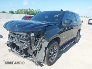 2023 Chevrolet Tahoe LT z VIN 1GNSCNKDXPR477061, wystawiony jako IAAI lot #42225743 z przebiegiem 57 077 mil mil oraz . Historia ofert i sprzedaży dostępna na DreamBid. Obrazek 2.