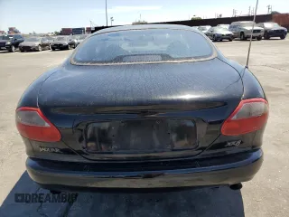 1997 Jaguar XK with VIN SAJGX5740VC014035, listed as a Copart auction lot 53066215 with 140,692 mi miles and Salvage Title. Bid and sale history available at DreamBid. Image 6.