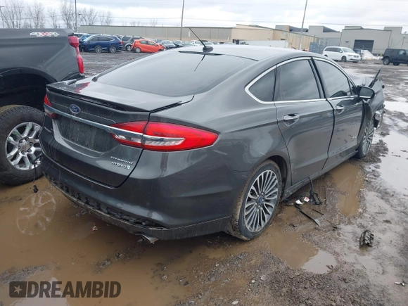 2017 Ford Fusion Hybrid Titanium z VIN 3FA6P0RU6HR279726, wystawiony jako IAAI lot #41736889 z przebiegiem 123 698 mil mil oraz . Historia ofert i sprzedaży dostępna na DreamBid. Obrazek 4.