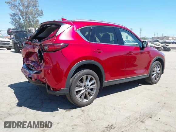 2021 Mazda CX-5 Grand Touring with VIN JM3KFADM5M0470483, listed as a IAAI auction lot 42785031 with 30,749 mi miles and . Bid and sale history available at DreamBid. Image 4.