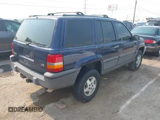 1994 Jeep Grand Cherokee Laredo z VIN 1J4GZ58Y7RC233746, wystawiony jako IAAI lot #42722206 z przebiegiem 196 875 mil mil oraz . Historia ofert i sprzedaży dostępna na DreamBid. Obrazek 4.