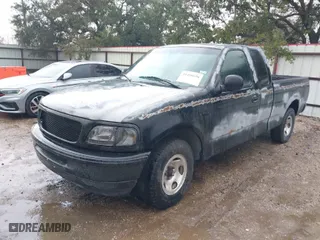 1997 Ford F-150 Standard with VIN 1FTDX1761VKC65051, listed as a IAAI auction lot 41450698 with 158,999 mi miles. Bid and sale history available at carsss.com. Image 2.