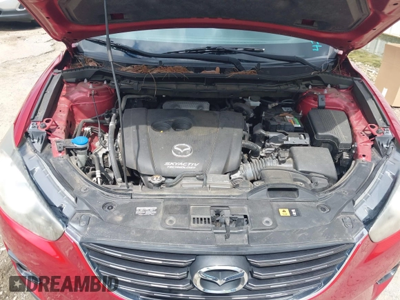 2016 Mazda CX-5 Grand Touring z VIN JM3KE2DY6G0693678, wystawiony jako IAAI lot #42443247 z przebiegiem 127 620 mil mil oraz . Historia ofert i sprzedaży dostępna na DreamBid. Obrazek 10.