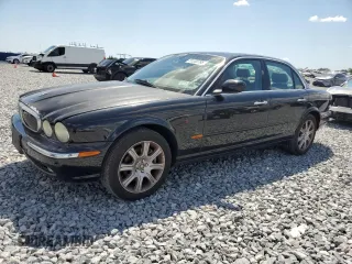 2004 Jaguar XJ with VIN SAJEA71C14SG10928, listed as a Copart auction lot 51202785 with 164,300 mi miles and Salvage Title. Bid and sale history available at carsss.com. Image 1.