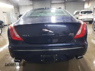 2014 Jaguar XJ Portfolio with VIN SAJWJ2GD5E8V69562, listed as a Copart auction lot 87737195 with 100,525 mi miles and Salvage title. Bid and sale history available at DreamBid. Image 6.