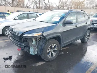 2015 Jeep Cherokee Trailhawk with VIN 1C4PJMBS9FW785545, listed as a IAAI auction lot 41573197 with 124,304 mi miles. Bid and sale history available at carsss.com. Image 2.