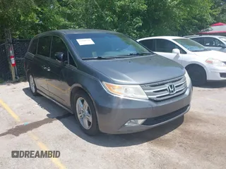 2013 Honda Odyssey Touring with VIN 5FNRL5H95DB030777, listed as a IAAI auction lot 42840230 with 151,357 mi miles and . Bid and sale history available at DreamBid. Image 1.