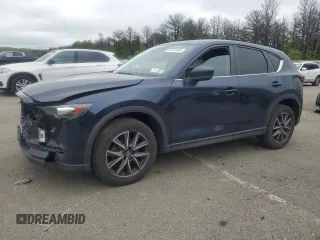 2018 Mazda CX-5 Touring z VIN JM3KFBCM7J1394911, wystawiony jako Copart lot #58761465 z przebiegiem 135 330 mil mil oraz Szkoda całkowita • Salvage title. Historia ofert i sprzedaży dostępna na DreamBid. Obrazek 1.