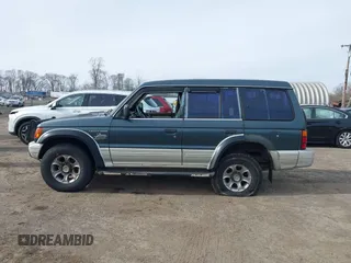 1995 Mitsubishi Montero z VIN JA4MR41H7SJ010597, wystawiony jako IAAI lot #41610885 z przebiegiem 162 406 mil mil oraz . Historia ofert i sprzedaży dostępna na DreamBid. Obrazek 14.