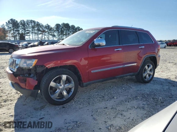 2011 Jeep Grand Cherokee Overland with VIN 1J4RS6GG7BC665979, listed as a Copart auction lot 83394214 with 216,988 mi miles and Salvage Title. Bid and sale history available at DreamBid. Image 1.