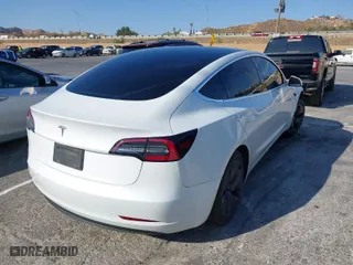 2020 Tesla Model 3 Standard Range Plus with VIN 5YJ3E1EA1LF615250, listed as a IAAI auction lot 41444030 with 76,810 mi miles. Bid and sale history available at carsss.com. Image 4.