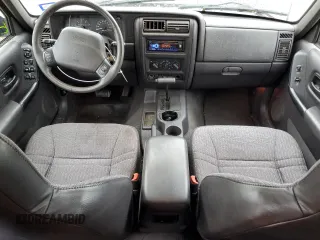 1999 Jeep Cherokee Sport with VIN 1J4FT68S2XL656679, listed as a Copart auction lot 88145875 with 254,038 mi miles and Salvage title. Bid and sale history available at DreamBid. Image 8.