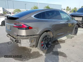 2016 Tesla Model X P90D with VIN 5YJXCAE45GF000773, listed as a IAAI auction lot 42052642 with 127,670 mi miles. Bid and sale history available at carsss.com. Image 4.