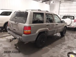 1998 Jeep Grand Cherokee Laredo with VIN 1J4GZ58S3WC343555, listed as a IAAI auction lot 41528943 with 219,146 mi miles. Bid and sale history available at carsss.com. Image 4.