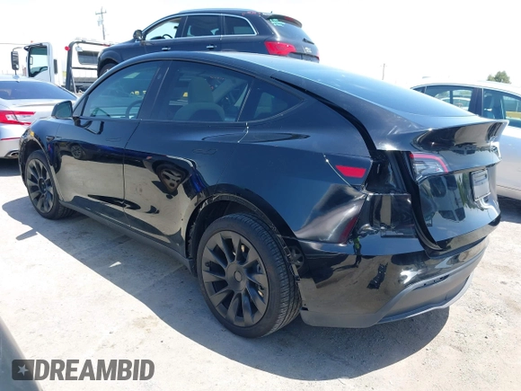 2024 Tesla Model Y with VIN 7SAYGDED9RF191453, listed as a IAAI auction lot 42272051 with 7,805 mi miles and . Bid and sale history available at DreamBid. Image 3.