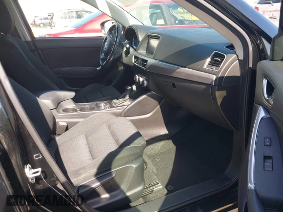 2016 Mazda CX-5 Touring z VIN JM3KE4CY2G0656270, wystawiony jako IAAI lot #42344489 z przebiegiem 60 449 mil mil oraz . Historia ofert i sprzedaży dostępna na DreamBid. Obrazek 5.