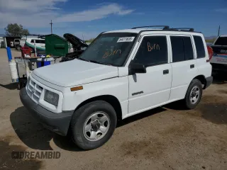 1996 Geo Tracker z VIN 2CNBE1364T6909947, wystawiony jako Copart lot #54411835 z przebiegiem 171 862 mil mil oraz Szkody całkowita. Historia ofert i sprzedaży dostępna na DreamBid. Obrazek 1.
