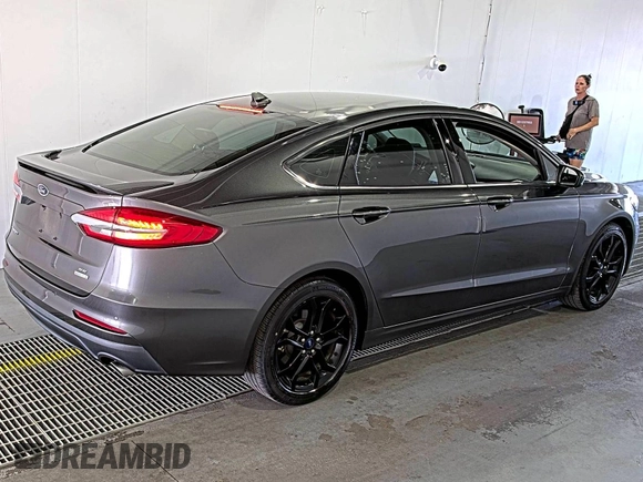 2020 Ford Fusion SE z VIN 3FA6P0HD6LR189762, wystawiony jako IAAI lot #42780149 z przebiegiem 51 099 mil mil oraz . Historia ofert i sprzedaży dostępna na DreamBid. Obrazek 5.
