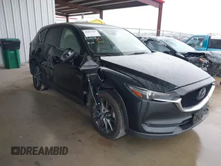 2021 Mazda CX-5 Signature with VIN JM3KFBEY5M0432033, listed as a IAAI auction lot 41607215 with 49,870 mi miles. Bid and sale history available at carsss.com. Image 1.