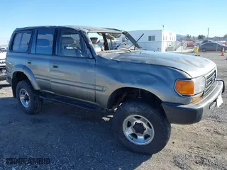 1997 Toyota Land Cruiser with VIN JT3HJ85JXV0174430, listed as a IAAI auction lot 41502690 with 300,632 mi miles. Bid and sale history available at carsss.com. Image 1.